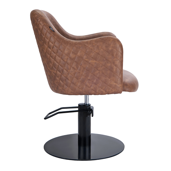 this salon chair is hydraulic with a black round base and pump