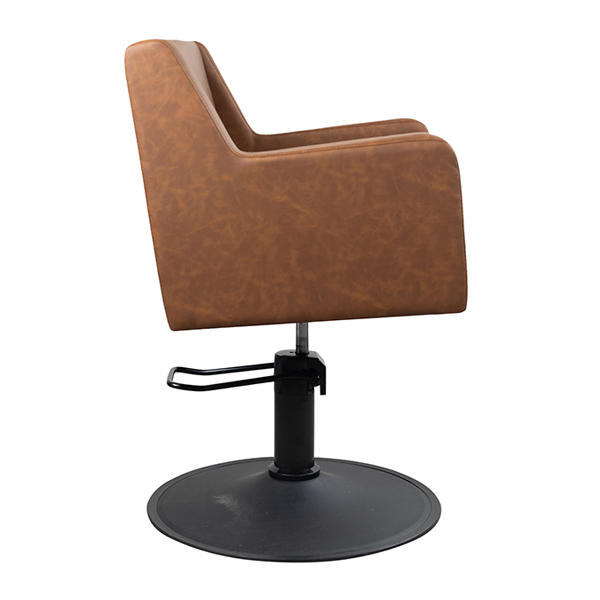 caruso salon chair with hydraulic lift and upholstered in tan vinyl